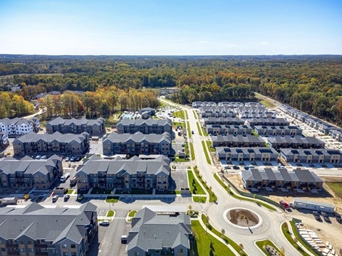 an aerial view of a neighborhood of houses with cars parked